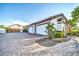 Exterior angle of the three-car garage and brick-paved driveway at 10059 W Villa Lindo Dr, Peoria, AZ 85383