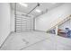Spacious garage with a staircase to the side and an automatic door at 10059 W Villa Lindo Dr, Peoria, AZ 85383