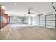 Spacious three-car garage with natural light and concrete flooring at 10059 W Villa Lindo Dr, Peoria, AZ 85383