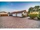 Charming home featuring a paver driveway leading to a spacious three-car garage and lush landscaping at 10059 W Villa Lindo Dr, Peoria, AZ 85383