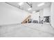 A large garage features an upstairs landing and ample space for storage and working at 10059 W Villa Lindo Dr, Peoria, AZ 85383