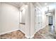 Hallway with porcelain tile floors, an inset display, and a closet at 10059 W Villa Lindo Dr, Peoria, AZ 85383