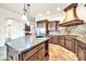Kitchen island with granite countertop, prep sink, and custom wood cabinets at 10059 W Villa Lindo Dr, Peoria, AZ 85383