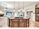 Kitchen island with granite countertop, ample cabinet space, and pendant lighting at 10059 W Villa Lindo Dr, Peoria, AZ 85383