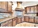 Custom kitchen features granite countertops, tiled backsplash, and wood cabinets at 10059 W Villa Lindo Dr, Peoria, AZ 85383