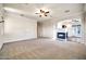 Spacious living room with fireplace, carpet, ceiling fan, and neutral paint at 10059 W Villa Lindo Dr, Peoria, AZ 85383