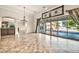 Living room with tile floors opens to an outdoor living space through sliding glass doors at 10059 W Villa Lindo Dr, Peoria, AZ 85383
