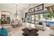 Bright living area flowing into dining, with outdoor views through expansive glass doors, offers luxurious comfort at 10059 W Villa Lindo Dr, Peoria, AZ 85383