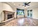 Spacious living room with a stone fireplace and tile floors at 10059 W Villa Lindo Dr, Peoria, AZ 85383