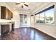 Bright living room with hardwood floors, a bar, and large windows showcasing backyard views at 10059 W Villa Lindo Dr, Peoria, AZ 85383