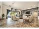 Open-concept living room with stone accent wall, TV, and sliding glass doors to a lush outdoor space at 10059 W Villa Lindo Dr, Peoria, AZ 85383