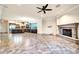 Spacious living room features tile flooring, fireplace, and open access to a modern kitchen at 10059 W Villa Lindo Dr, Peoria, AZ 85383