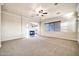 Open floor plan with carpet, ceiling fan, fireplace, and large windows at 10059 W Villa Lindo Dr, Peoria, AZ 85383