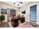 Comfortable home office featuring a wooden desk, leather chair, and a view of the outdoors at 10059 W Villa Lindo Dr, Peoria, AZ 85383