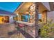 Stylish outdoor bar area with stone accents and seating for entertaining at 10059 W Villa Lindo Dr, Peoria, AZ 85383