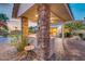 Outdoor kitchen with stone pillars offering serene views of the backyard at 10059 W Villa Lindo Dr, Peoria, AZ 85383
