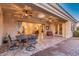Elegant covered patio with comfortable seating and ornate metal table at 10059 W Villa Lindo Dr, Peoria, AZ 85383