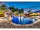 Inviting pool with a rock waterfall, slide, and lush greenery, perfect for relaxation and outdoor fun at 10059 W Villa Lindo Dr, Peoria, AZ 85383
