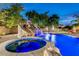 Stunning pool with slide, waterfall, and spa, perfect for relaxing evenings in a lush backyard setting at 10059 W Villa Lindo Dr, Peoria, AZ 85383