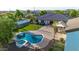 Aerial view of a custom pool, spa, and outdoor entertaining area with lush landscaping at 10059 W Villa Lindo Dr, Peoria, AZ 85383