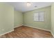 Bedroom featuring vinyl flooring and a window at 10817 W Wilshire Dr, Avondale, AZ 85392