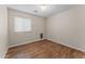 Bedroom featuring wood floors and window at 10817 W Wilshire Dr, Avondale, AZ 85392