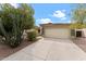 Attractive home with a large driveway, two-car garage, and easy-care desert landscaping at 10817 W Wilshire Dr, Avondale, AZ 85392