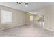 Spacious living room with tiled floors, recessed lighting, and a large window at 10817 W Wilshire Dr, Avondale, AZ 85392