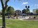 Community playground with slides, gazebo, and mature shade trees on a sunny day, Gathering-friendly environment at 10817 W Wilshire Dr, Avondale, AZ 85392