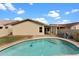 Backyard view with a sparkling pool and well-manicured lawn at 10817 W Wilshire Dr, Avondale, AZ 85392