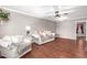 Inviting living room with hardwood floors, neutral walls, modern lighting, and comfortable seating at 11122 W Desert Butte Dr, Sun City, AZ 85351
