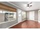 Bright sun room with hardwood floors, a ceiling fan, and access to an outdoor patio area at 11122 W Desert Butte Dr, Sun City, AZ 85351