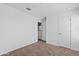 Bright bedroom featuring neutral carpet, white walls, and a closet for ample storage at 148 E Douglas Ave, Coolidge, AZ 85128
