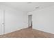Carpeted bedroom with door, window, and view into a closet at 148 E Douglas Ave, Coolidge, AZ 85128