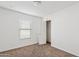 Empty bedroom featuring carpet, a window, and white walls at 148 E Douglas Ave, Coolidge, AZ 85128