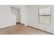 Unfurnished living space featuring luxury vinyl floors, neutral walls and a bright window at 148 E Douglas Ave, Coolidge, AZ 85128