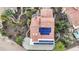 Stunning aerial view showcases a desert home, terracotta roof, solar panels, lush landscaping, and a serene backyard pool at 15948 W Sheila Ln, Goodyear, AZ 85395