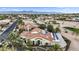Expansive aerial view showcases a desert home with solar panels, mountain views, and well manicured landscaping at 15948 W Sheila Ln, Goodyear, AZ 85395