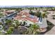 Expansive aerial view showcases a desert home with solar panels, fountain, and well manicured landscaping at 15948 W Sheila Ln, Goodyear, AZ 85395