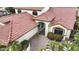 Beautiful aerial view of a home with landscaped yard near a gated entrance and tile roof at 15948 W Sheila Ln, Goodyear, AZ 85395
