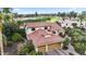 Breathtaking aerial of a home with landscaped yard situated on a well-maintained golf course and pond at 15948 W Sheila Ln, Goodyear, AZ 85395
