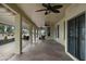 Spacious covered patio featuring stained concrete, ceiling fans and ample space for outdoor dining and lounging at 15948 W Sheila Ln, Goodyear, AZ 85395