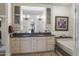 Elegant bathroom with double vanities, granite countertops, and a luxurious bathtub at 15948 W Sheila Ln, Goodyear, AZ 85395