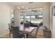 A cozy dining area with wood table and picturesque views of the golf course at 15948 W Sheila Ln, Goodyear, AZ 85395