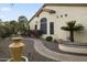 A well-maintained desert landscape featuring brick pathways with multiple fountains and mature trees at 15948 W Sheila Ln, Goodyear, AZ 85395