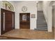 Grand foyer features a staircase, tile flooring, and an arched window above the door at 15948 W Sheila Ln, Goodyear, AZ 85395