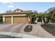 Lovely two-story home showcasing a spacious three-car garage, landscaped front yard, and tiled roof at 15948 W Sheila Ln, Goodyear, AZ 85395
