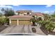 Charming two-story home featuring a three-car garage, landscaped front yard, and tiled roof at 15948 W Sheila Ln, Goodyear, AZ 85395