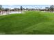 Green golf course landscape featuring a fairway and a pond at 15948 W Sheila Ln, Goodyear, AZ 85395
