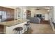 Spacious kitchen with granite countertops flows seamlessly into the living room, perfect for entertaining at 15948 W Sheila Ln, Goodyear, AZ 85395
